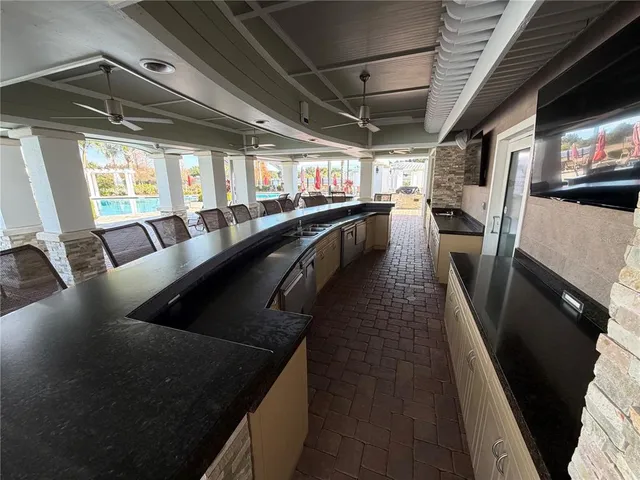 a view of backyard with barbeque grill and outdoor seating