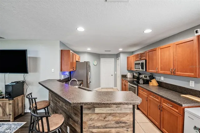 a kitchen with a stove a sink and a refrigerator