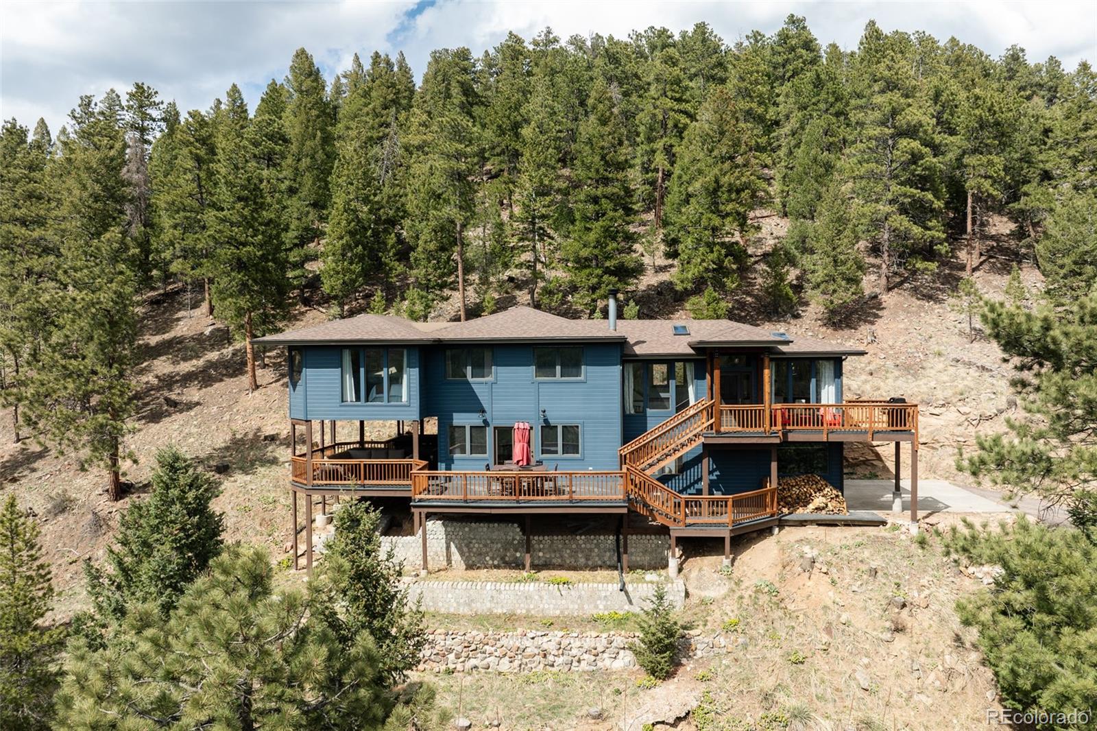 7290 Timber Trail Road Evergreen, CO 80439 - Photo 11 of 11 a front view of a house with patio