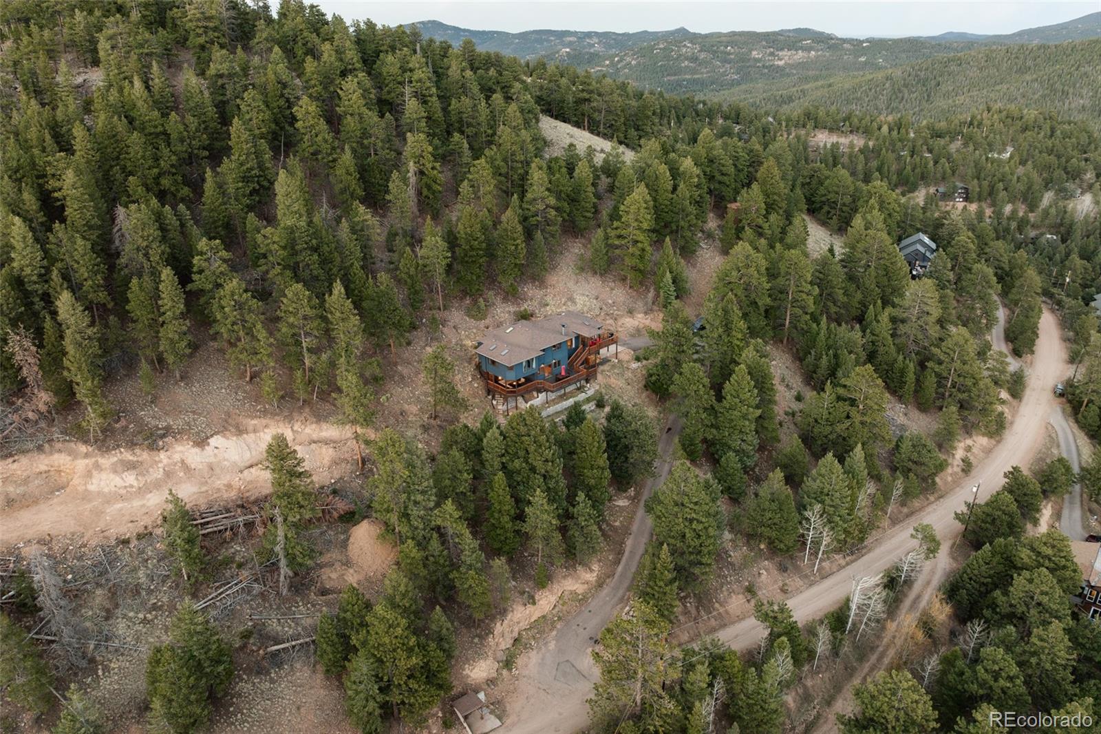 7290 Timber Trail Road Evergreen, CO 80439 - Photo 5 of 11 an aerial view of residential house with outdoor space and trees all around