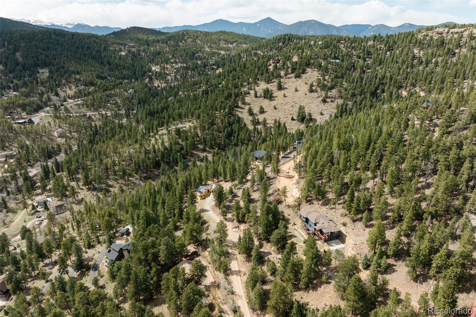 7290 Timber Trail Road Evergreen, CO 80439 - Photo 8 of 11 a view of a city with lush green forest