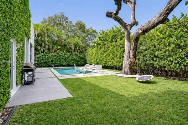 a view of a backyard with large trees