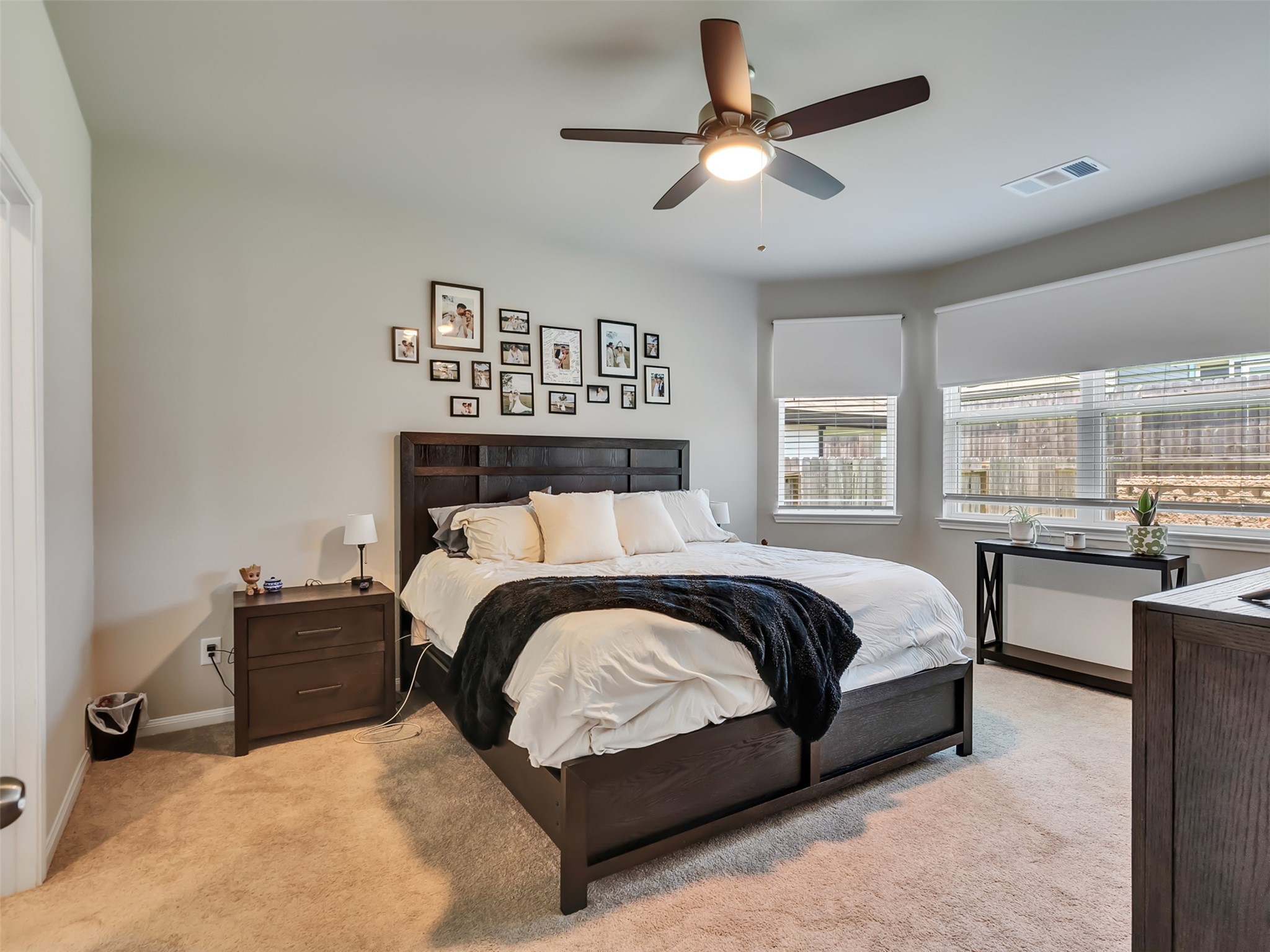 2416 Bluefish Court Conroe, TX 77384 - Photo 33 of 45 a bedroom with a large bed and a chandelier