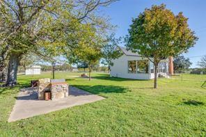 3952 Tin Top Road Weatherford, TX 76087 - Photo 13 of 39 a view of a house with garden and a bench