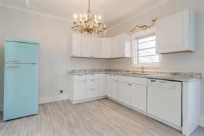 3952 Tin Top Road Weatherford, TX 76087 - Photo 8 of 39 a kitchen with granite countertop white cabinets and white appliances