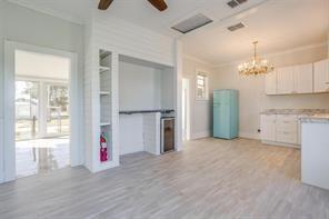 3952 Tin Top Road Weatherford, TX 76087 - Photo 9 of 39 a view of a kitchen with a refrigerator and cabinets
