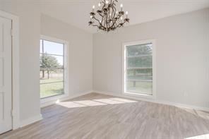 3952 Tin Top Road Weatherford, TX 76087 - Photo 10 of 39 an empty room with wooden floor and windows