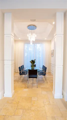 a kitchen with a sink dishwasher and a dining table with wooden floor