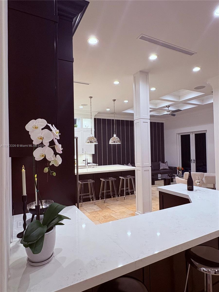 959 Eve Street Delray Beach, FL 33483 - Photo 16 of 74 a kitchen with a sink dishwasher and a dining table with wooden floor