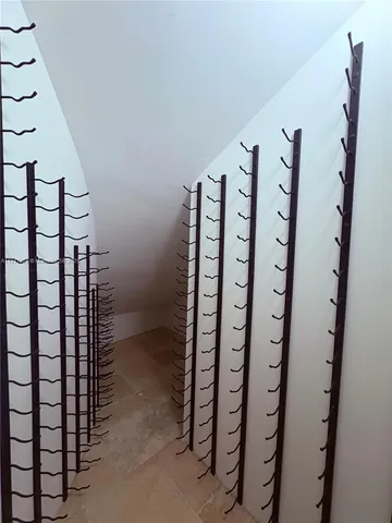 a room with kitchen island a sink and a wooden floor