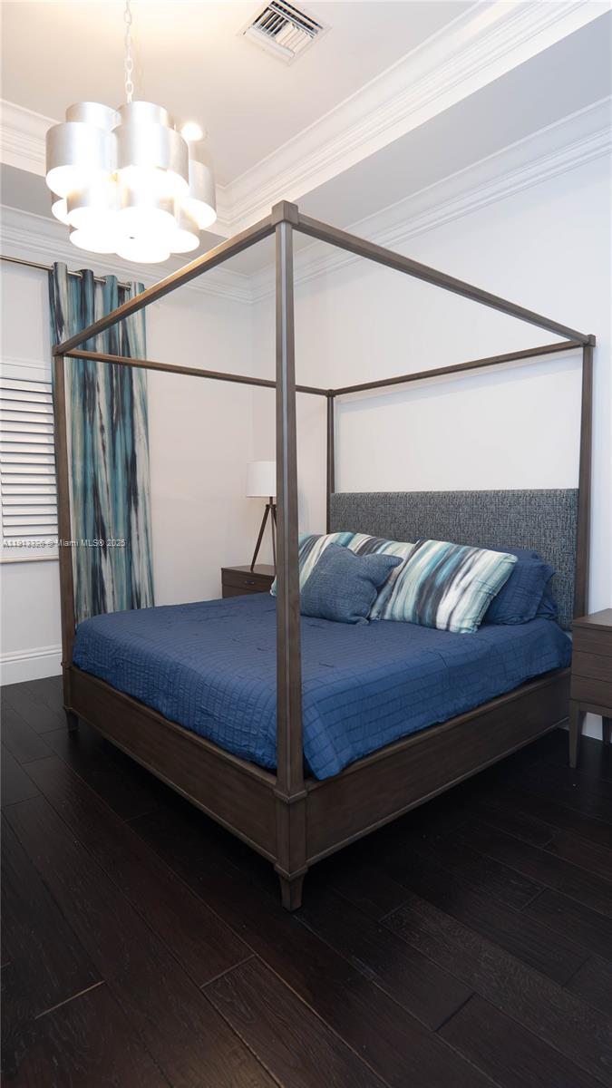 959 Eve Street Delray Beach, FL 33483 - Photo 49 of 74 a bedroom with a bed and wooden floor