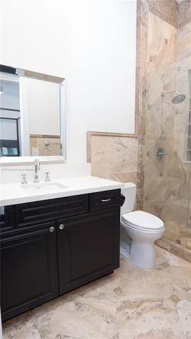 a view of a balcony with wooden floor space and a potted plant