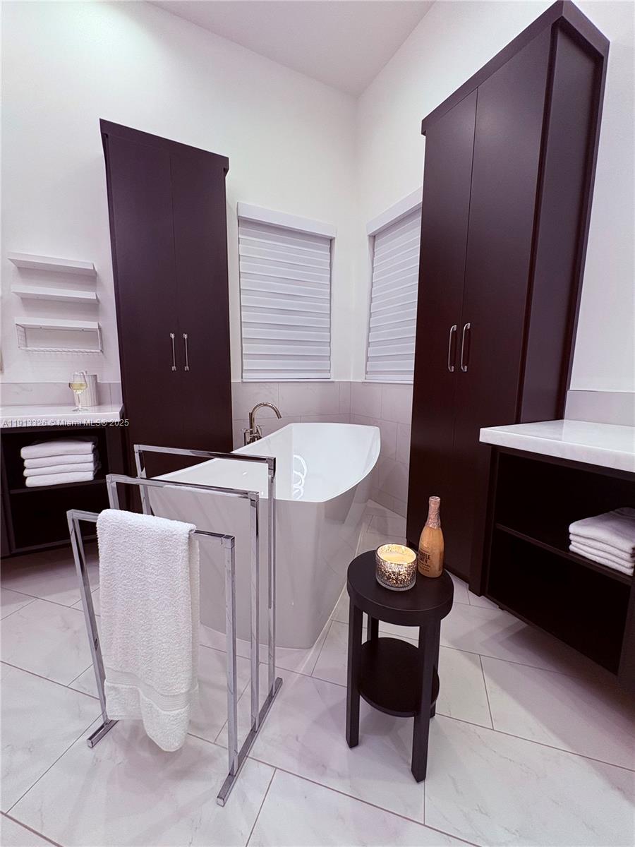 959 Eve Street Delray Beach, FL 33483 - Photo 66 of 74 a living room with furniture and a potted plant