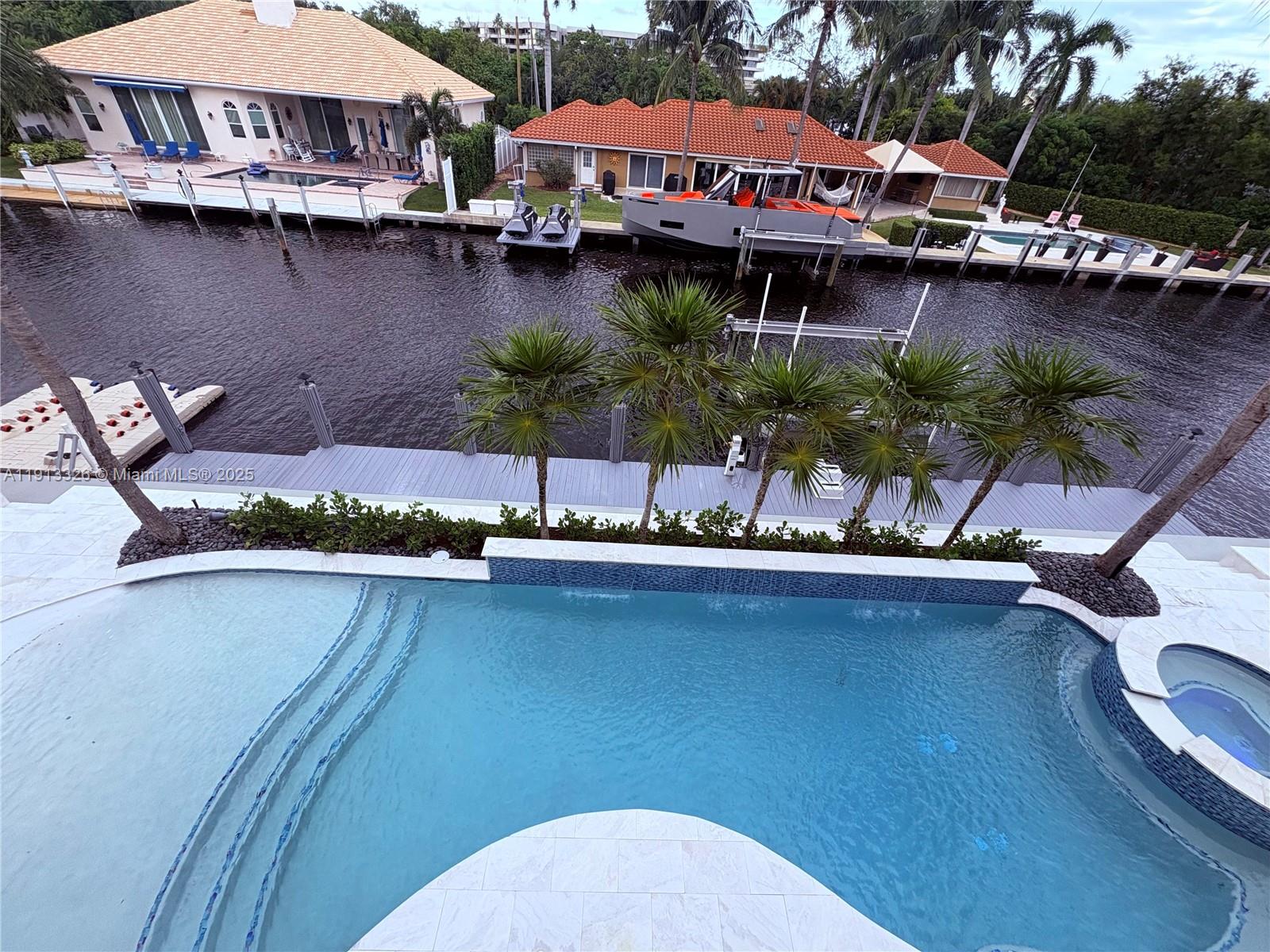 959 Eve Street Delray Beach, FL 33483 - Photo 69 of 74 a front view of a house with swimming pool and outdoor seating