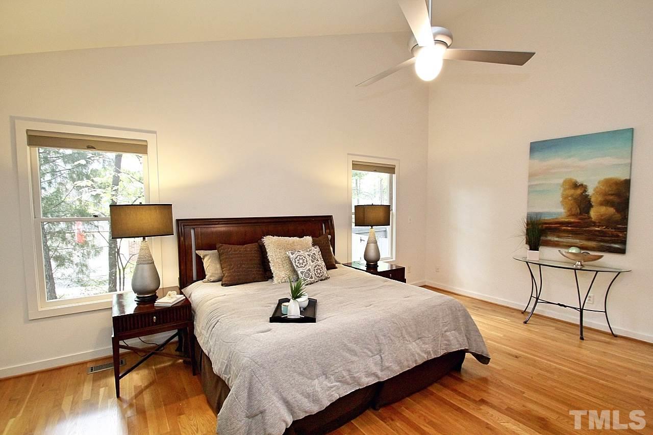 122 Queensferry Road Cary, NC 27511 - Photo 11 of 25 a bedroom with a bed and wooden floor