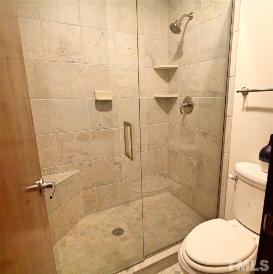 122 Queensferry Road Cary, NC 27511 - Photo 18 of 25 a bathroom with a toilet and shower