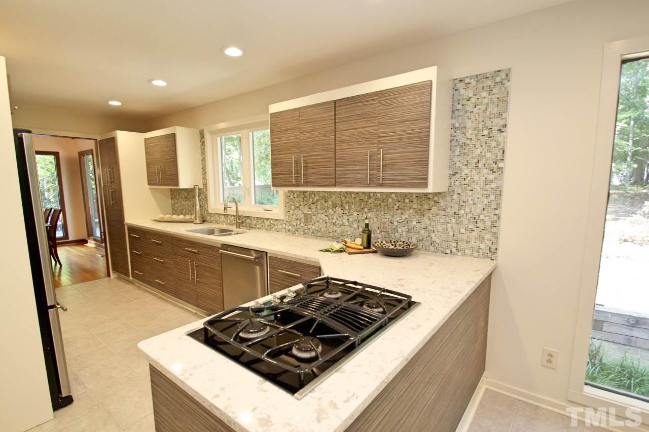 122 Queensferry Road Cary, NC 27511 - Photo 5 of 25 a kitchen with a stove a sink and a refrigerator