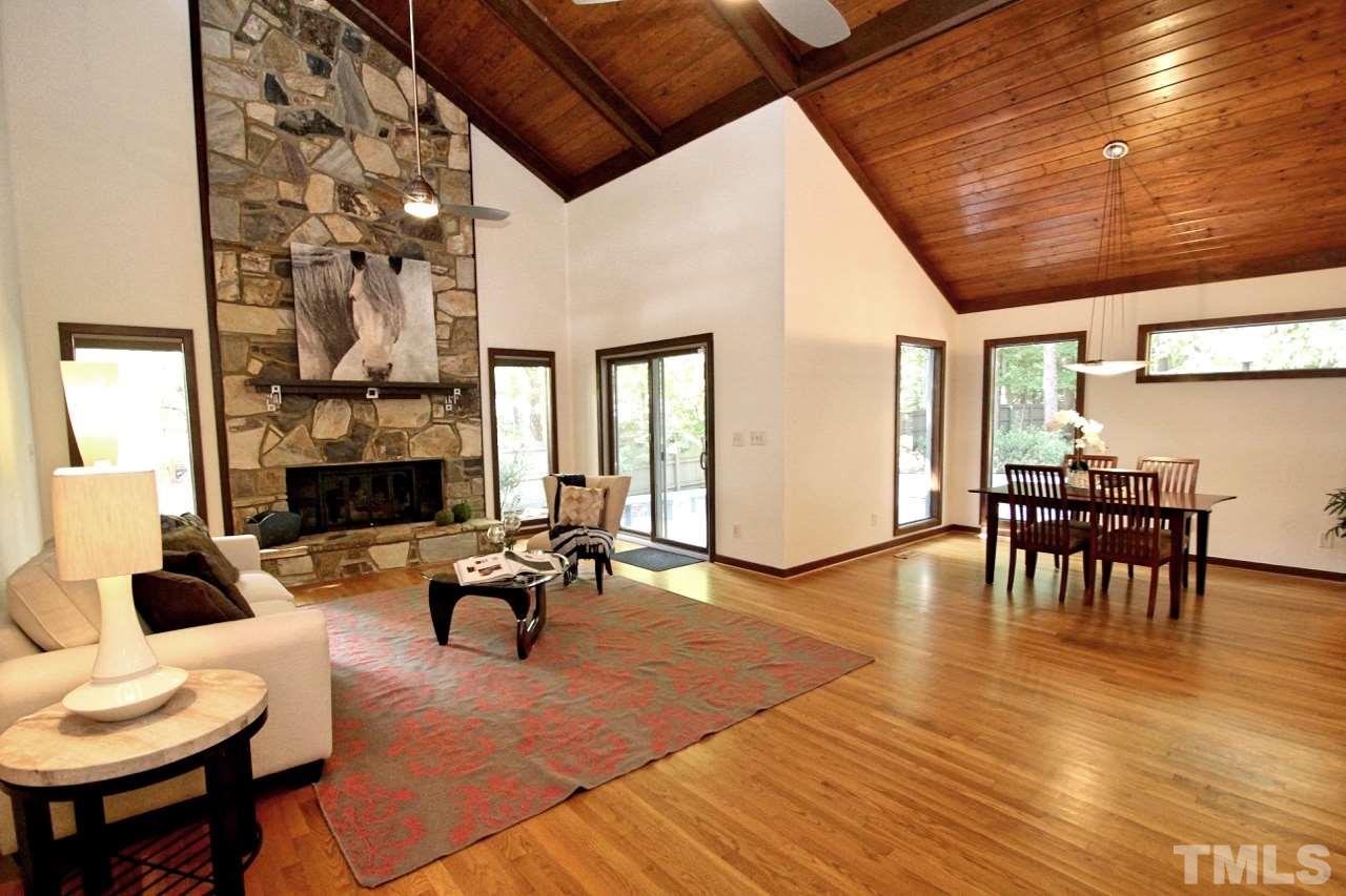 122 Queensferry Road Cary, NC 27511 - Photo 8 of 25 a living room with furniture a fireplace and a flat screen tv