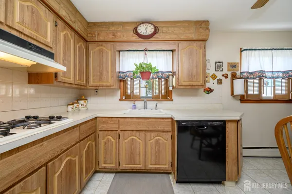 a kitchen with a sink cabinets and window