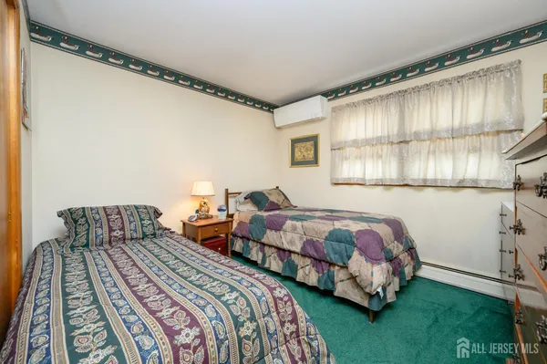 a bedroom with two beds and a window