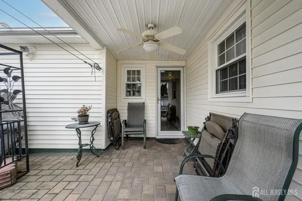 a view of patio with a table and chairs