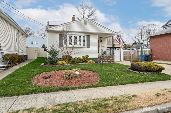 a front view of a house with a garden and plants
