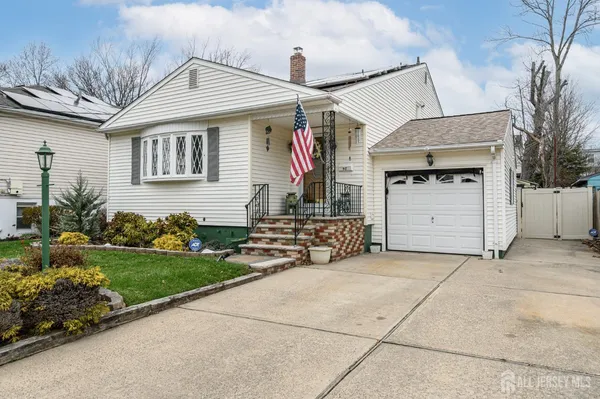 a view of a house with a yard and a garage