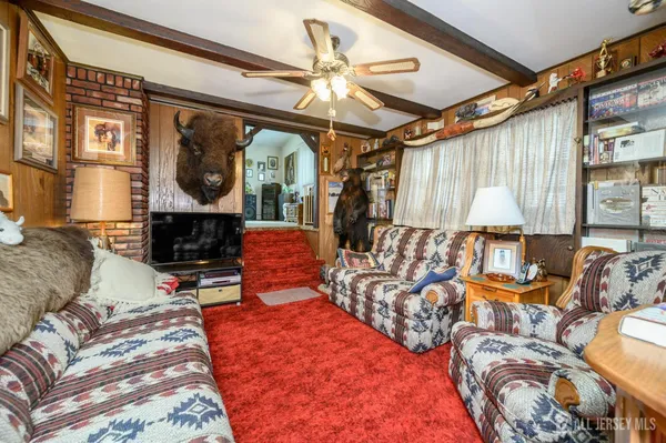 a bedroom with furniture and a large window