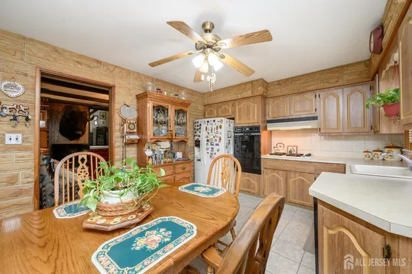 a dinning table and chairs in a kitchen