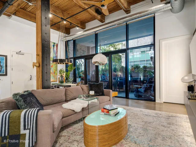 a bedroom with a bed and a potted plant on the dresser