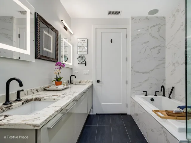 a bathroom with a granite countertop sink mirror and toilet