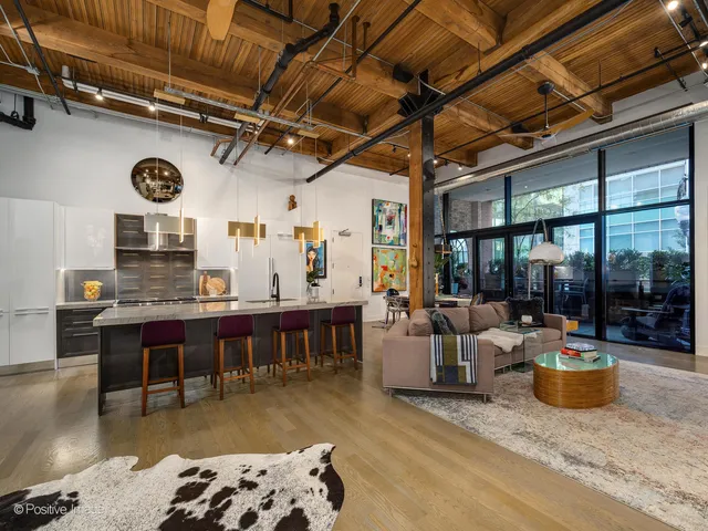 a living room with lots of furniture and view of kitchen