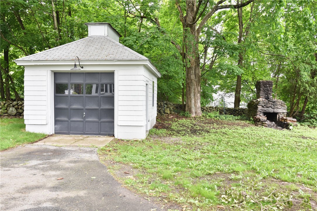 2745 Diamond Hill Road Cumberland, RI 02864 - Photo 32 of 38 One car garage and outdoor fireplace