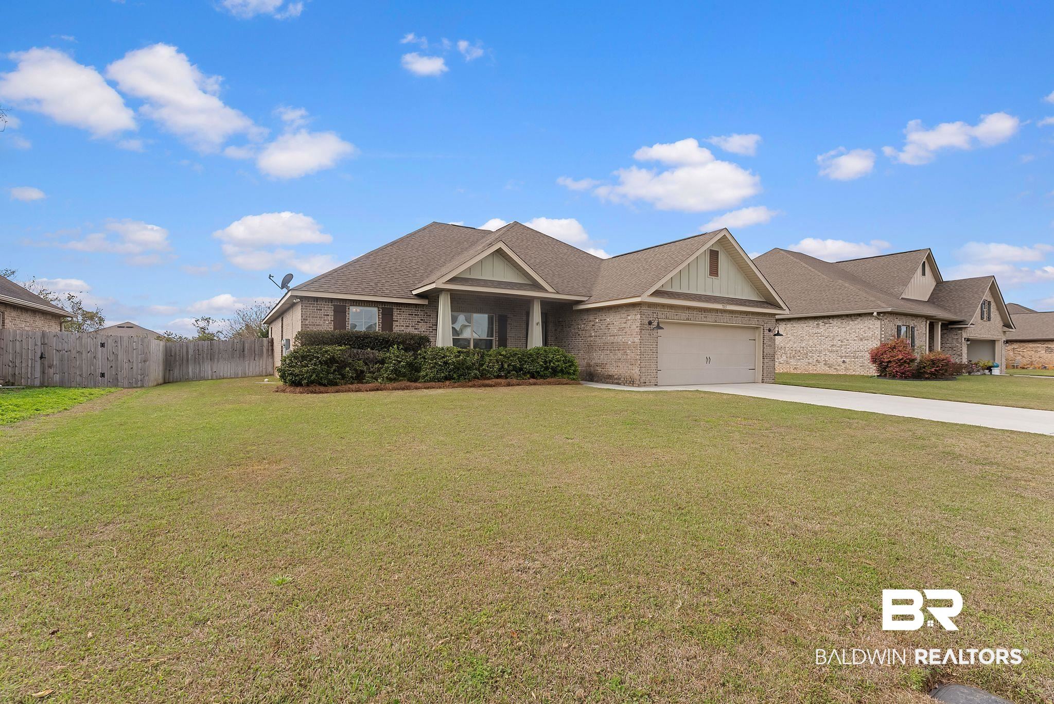 7015 Rocky Rd Loop Gulf Shores, AL 36542 - Photo 2 of 41 Craftsman inspired home featuring brick siding, driveway, a garage, and roof with shingles