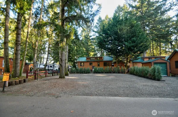 a row of palm trees in front of a house