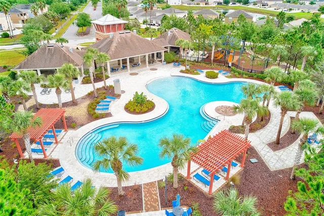 a view of a swimming pool with outdoor seating