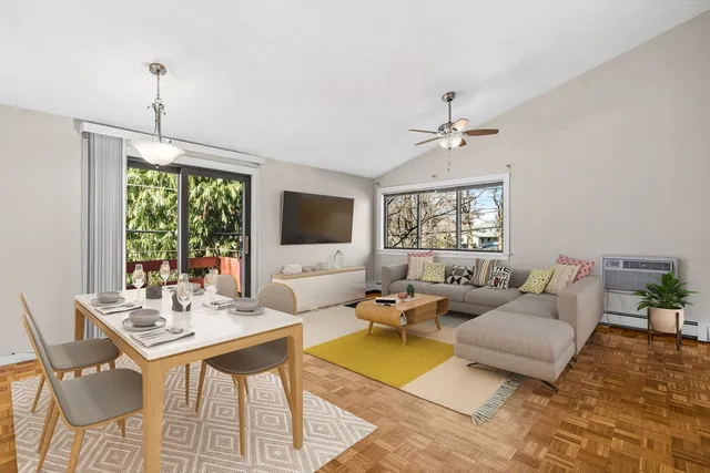 a living room with furniture a flat screen tv and a chandelier