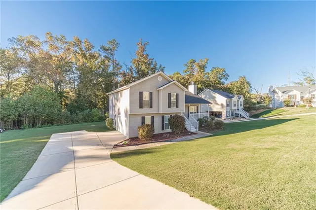 a front view of a house with swimming pool having outdoor seating