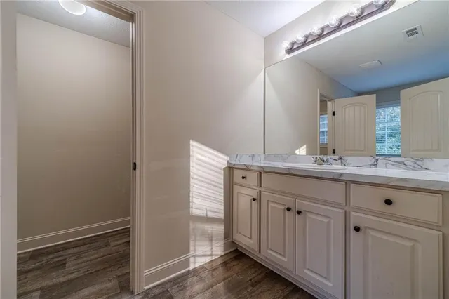 a bathroom with a granite countertop sink and a mirror