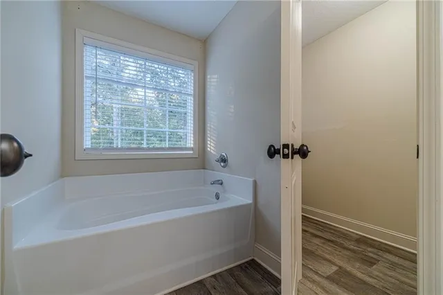 a white bath tub sitting next to a window