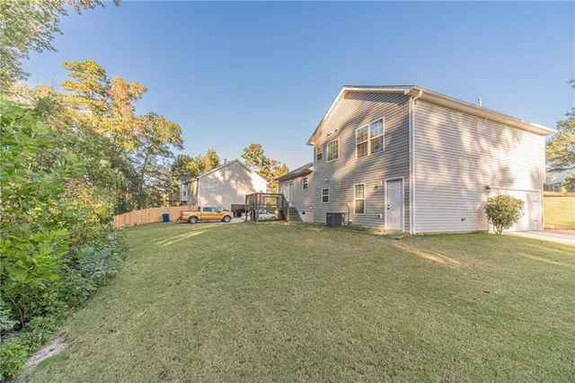 a backyard of a house with table and chairs