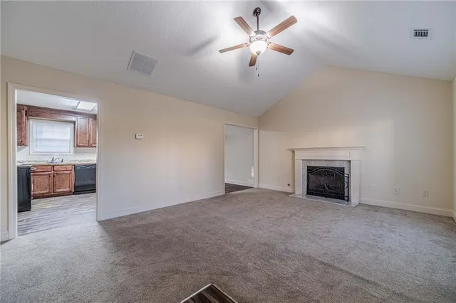 a view of an empty room with a fireplace