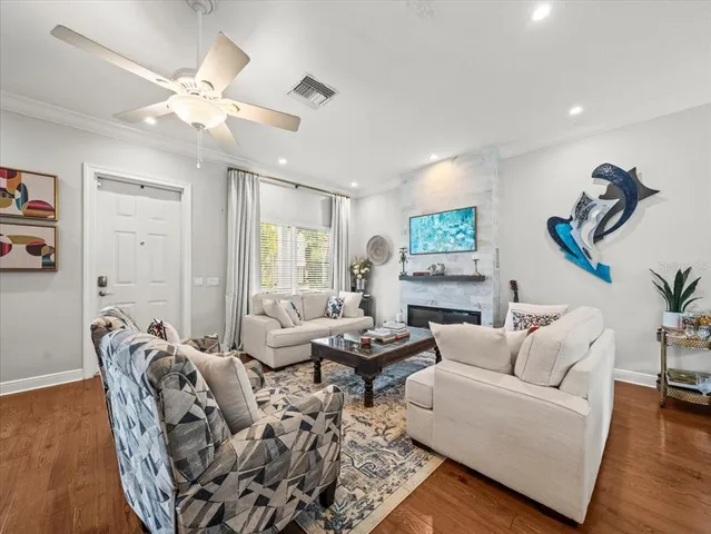 a living room with furniture and wooden floor