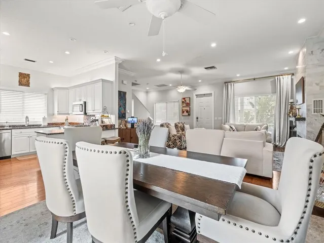 a living room with furniture a kitchen and a dining table