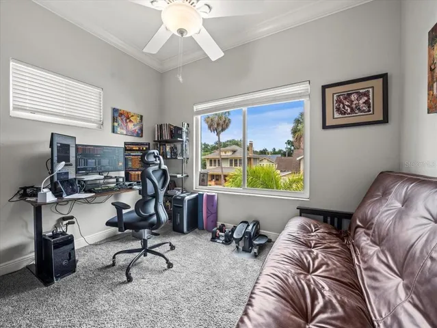 a living room with furniture a window and gym equipment