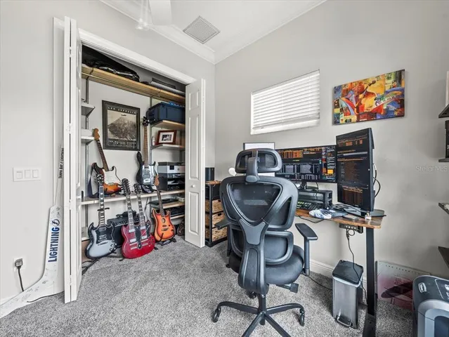 a view of a workspace with furniture and closet