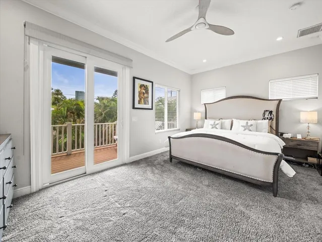 a spacious bedroom with a bed and a large window