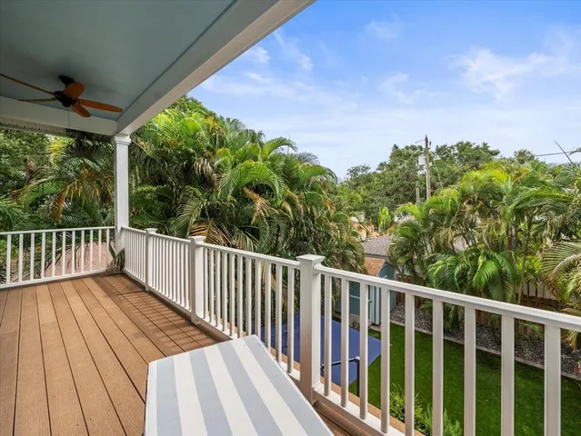 a balcony with wooden floor and outdoor space