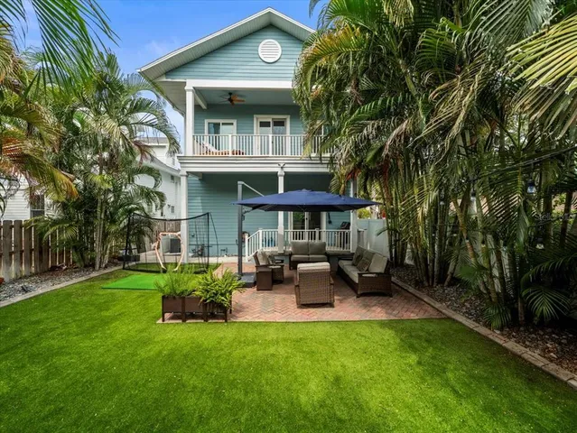 a view of a chair and table in backyard of the house