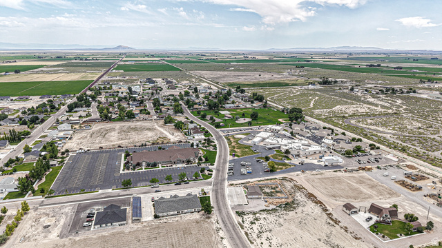 84 White Sage Avenue, Unit 2 Delta, UT 84624 - Photo 11 of 18 Expansive aerial perspective showcasing a rural community with surrounding agricultural fields and distant mountain ranges